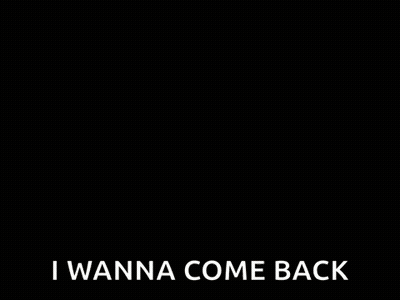 A Woman Wearing Glasses Is Sitting At A Table And Saying `` Surprise ! I Wanna Come Back '' . GIF