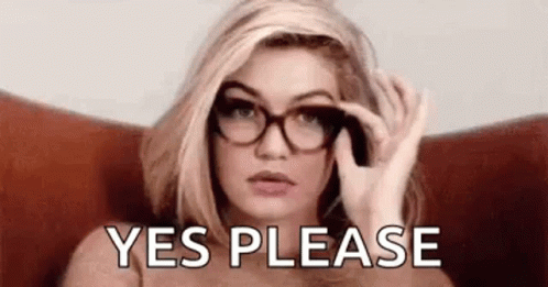 A Woman Wearing Glasses Is Sitting In A Chair And Holding Her Glasses In Her Hand . GIF
