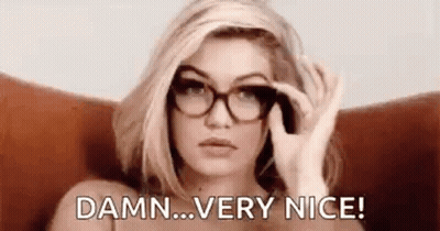 A Woman Wearing Glasses Is Sitting In A Chair And Saying `` Damn ... Very Nice '' . GIF