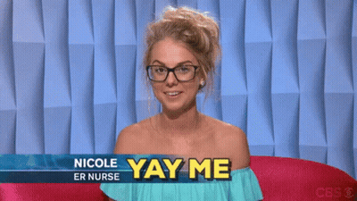 A Woman Wearing Glasses Is Sitting In Front Of A Sign That Says " Nicole Er Nurse Yay Me " GIF