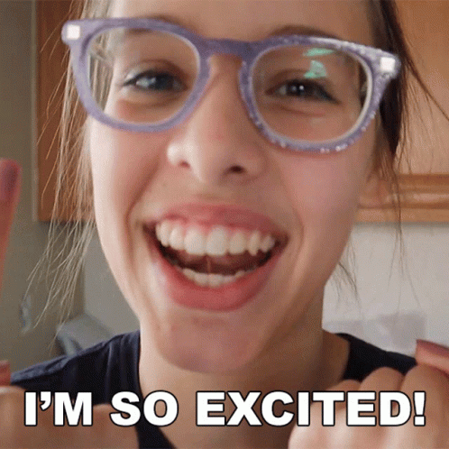 A Woman Wearing Glasses Is Smiling With The Words I 'M So Excited Below Her GIF