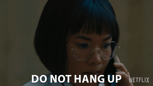 A Woman Wearing Glasses Is Talking On A Cell Phone With The Words Do Not Hang Up Netflix Below Her GIF