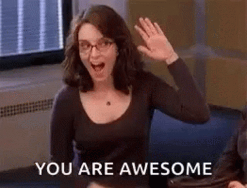 A Woman Wearing Glasses Is Waving Her Hand In Front Of A Window And Says `` You Are Awesome '' . GIF
