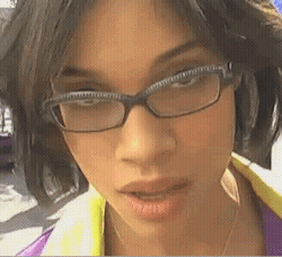 A Woman Wearing Glasses Looks At The Camera With Her Mouth Open GIF