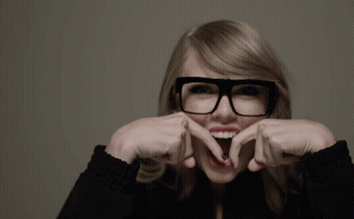 A Woman Wearing Glasses Making A Funny Face GIF