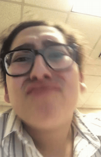 A Woman Wearing Glasses Making A Funny Face GIF