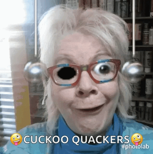 A Woman Wearing Glasses Says Cuckoo Quackers In A Photo Lab GIF