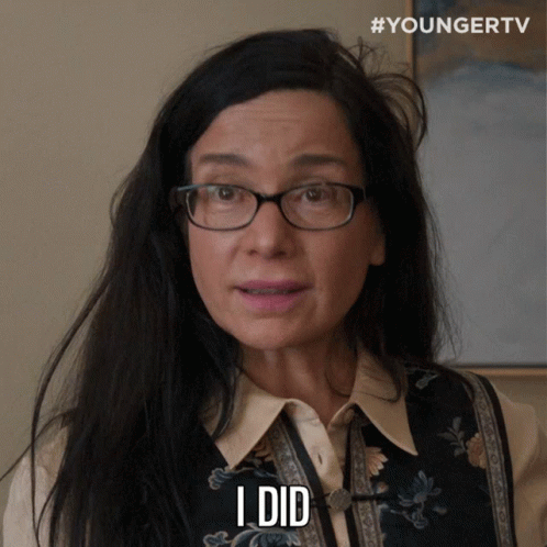 A Woman Wearing Glasses Says " I Did " In Front Of A Younger Tv Logo GIF