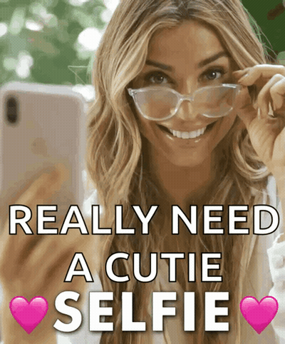 A Woman Wearing Glasses Takes A Selfie With The Words Really Need A Cutie Selfie GIF