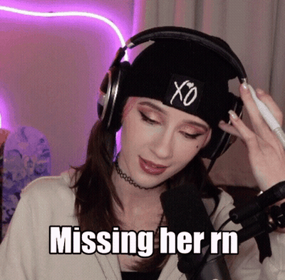A Woman Wearing Headphones And A Beanie Is Missing Her Rn GIF