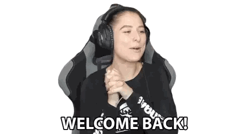 A Woman Wearing Headphones And A Black Shirt Is Sitting In A Chair And Says Welcome Back . Sticker