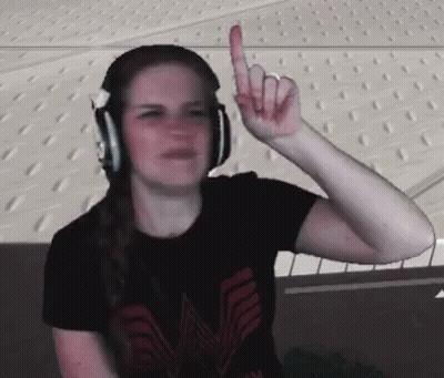 A Woman Wearing Headphones And A Black Shirt With The Letter M On It GIF