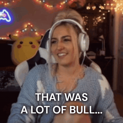 A Woman Wearing Headphones And A Blue Sweater Is Sitting In A Chair . GIF