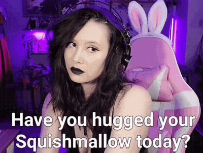 A Woman Wearing Headphones And A Bunny Headband Is Asking If She Hugged Her Squishmallow Today GIF