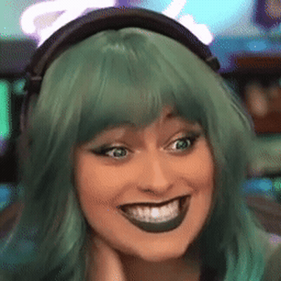 A Woman Wearing Headphones And A Green Wig Is Smiling GIF