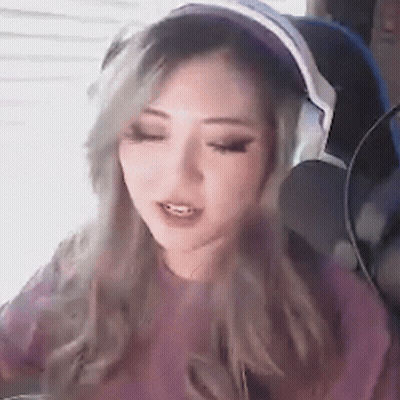 A Woman Wearing Headphones And A Pink Shirt GIF