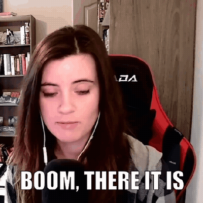 A Woman Wearing Headphones And A Red Chair Is Sitting In Front Of A Microphone With The Words Boom , There It Is . GIF