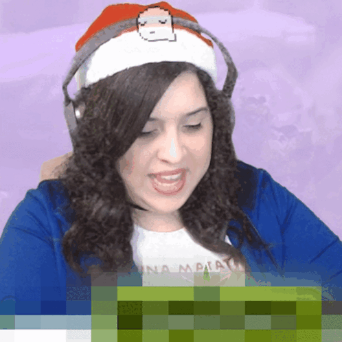 A Woman Wearing Headphones And A Santa Hat With A Pixelated Face GIF