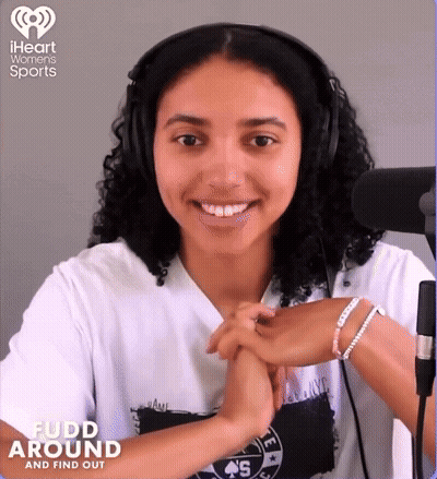 A Woman Wearing Headphones And A Shirt That Says ' Fudd Around ' On It GIF