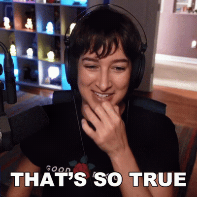 A Woman Wearing Headphones And A Shirt That Says Good On It GIF