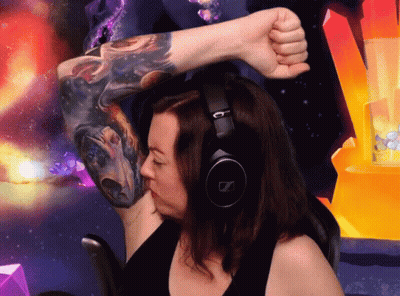 A Woman Wearing Headphones And A Tattoo On Her Arm GIF