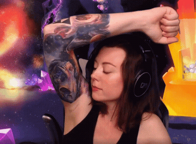 A Woman Wearing Headphones And A Tattoo On Her Arm GIF