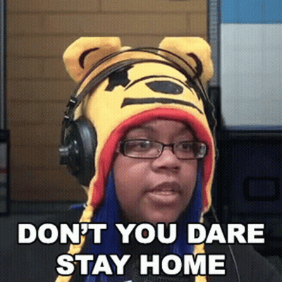 A Woman Wearing Headphones And A Winnie The Pooh Hat Says " Don T You Dare Stay Home " GIF