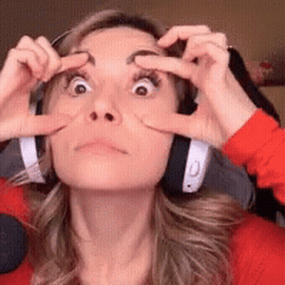 A Woman Wearing Headphones Has Her Hands On Her Eyes GIF