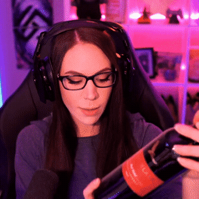 A Woman Wearing Headphones Holds A Bottle Of Wine GIF