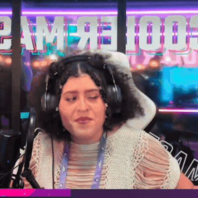 A Woman Wearing Headphones In Front Of A Sign That Says " Game 100 " GIF