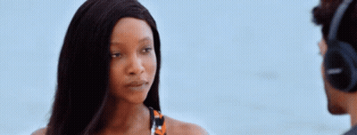 A Woman Wearing Headphones Is Looking At A Man GIF