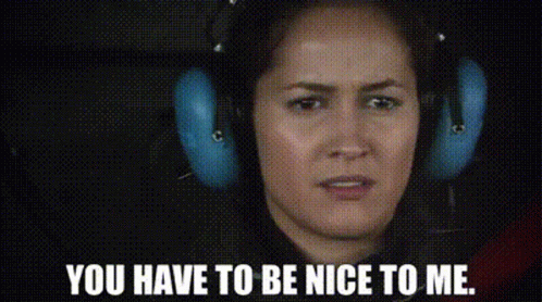 A Woman Wearing Headphones Is Making A Face And Saying `` You Have To Be Nice To Me '' . GIF