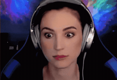 A Woman Wearing Headphones Is Making A Funny Face GIF