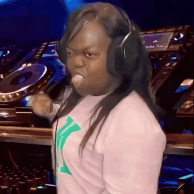 A Woman Wearing Headphones Is Making A Funny Face In Front Of A Dj GIF