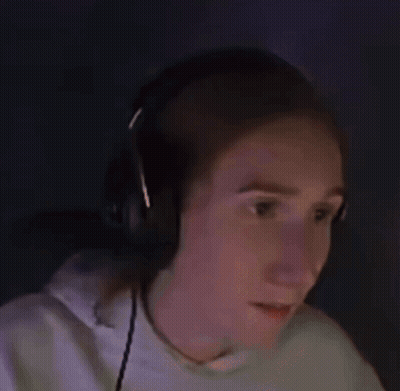 A Woman Wearing Headphones Is Making A Surprised Face While Playing A Video Game . GIF
