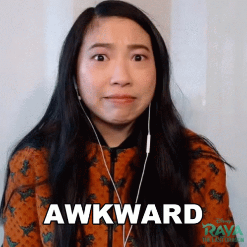 A Woman Wearing Headphones Is Making An Awkward Face While Looking At The Camera . GIF