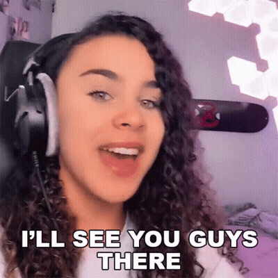A Woman Wearing Headphones Is Saying " I 'Ll See You Guys There " GIF