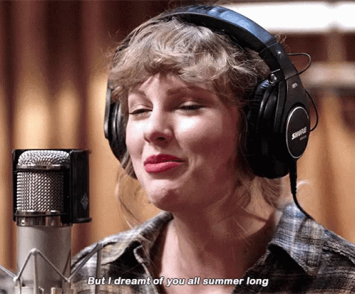 A Woman Wearing Headphones Is Singing Into A Microphone And Says " But I Dreamt Of You All Summer Long " GIF