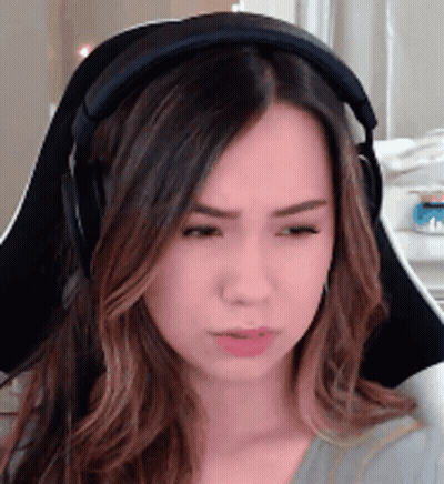 A Woman Wearing Headphones Is Sitting In A Chair And Making A Funny Face . GIF