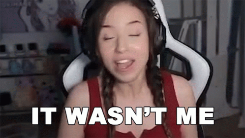 A Woman Wearing Headphones Is Sitting In A Chair And Says `` It Wasn 'T Me '' . GIF