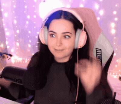 A Woman Wearing Headphones Is Sitting In A Chair That Says Intel On It GIF