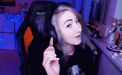 A Woman Wearing Headphones Is Sitting In A Chair That Says Quef On It GIF