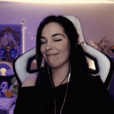 A Woman Wearing Headphones Is Sitting In A Chair With Her Eyes Closed GIF