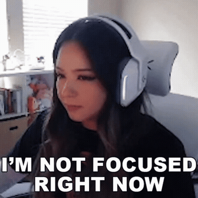 A Woman Wearing Headphones Is Sitting In Front Of A Computer . GIF