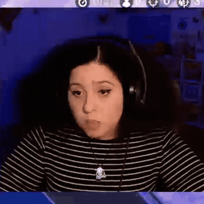 A Woman Wearing Headphones Is Sitting In Front Of A Computer Screen With The Words Ok Cool Written On It . GIF