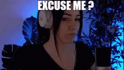 A Woman Wearing Headphones Is Sitting In Front Of A Microphone And Says `` Excuse Me ? '' GIF
