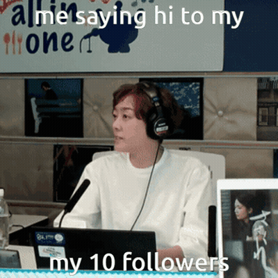 A Woman Wearing Headphones Is Sitting In Front Of A Microphone With The Words " All Me Saying Hi To My 10 Followers " Be GIF