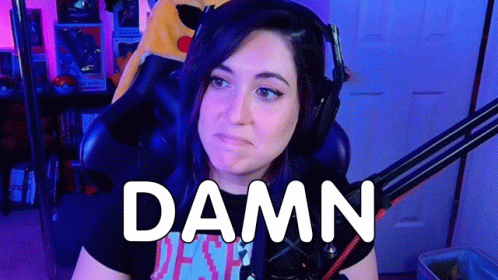 A Woman Wearing Headphones Is Sitting In Front Of A Microphone With The Words `` Damn '' Written On Her Face . GIF