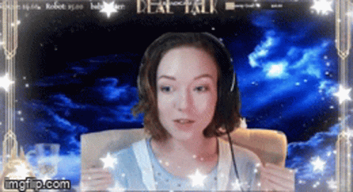 A Woman Wearing Headphones Is Sitting In Front Of A Screen That Says " Deal Talk " GIF