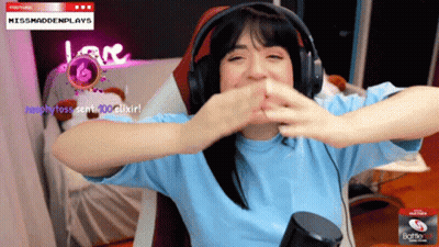 A Woman Wearing Headphones Is Sitting In Front Of A Screen That Says Missmaddenplays On It GIF